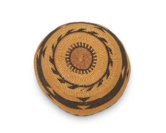 38
A polychrome Hupa/Yurok/Karuk basketry hat
Early 20th century; Northern California
A twined hat with an imbricated geometric band to center and hooked banding to crown and edge
3" H x 6.75" W x 7" D approximately
Estimate: $400 - $600