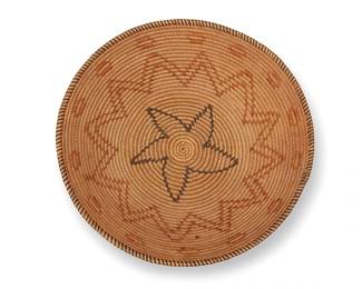 121
A polychrome Chemehuevi basket
Early/mid- 20th century; Great Basin/Southwest United States
A coiled basketry tray with rim ticking, double zigzag banding, floating motifs to rim and a whirled star motif center
3.75" H x 14" Dia.
Estimate: $600 - $900