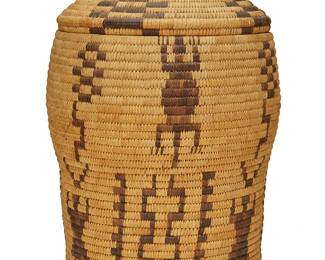 372
A large Papago pictorial lidded basket
Early/mid-20th century, Tohono O'odham; Arizona
An extra-large coiled jar with domed lid featuring alternating columns of figural and geometric motifs, with checkerboard motifs to lid
16.5" H x 12.25" Dia.
Estimate: $400 - $600