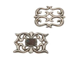 316
Two Navajo sandcast sterling silver belt buckles
Mid-20th century; Diné
Each unmarked
Comprising two openwork cast silver buckles, one with a central set oval chrysocolla stone
2 pieces
Large buckle: 2.25" H x 3.625" W; swivel bar: 1.375" H, Small buckle: 2.625" H x 3.5" W; swivel bar: 1.625" H
166.0 grams gross
Estimate: $400 - $600