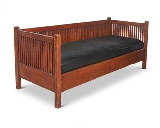 124
A Gustav Stickley settle, no. 291
1907-1912; Eastwood, NY
With applied Gustav Stickley Craftsman paper label
The even-arm spindle settle with spindle back and siding, featuring a drop-in spring seat cushion upholstered in black leather, below three later added cotton-upholstered back cushions
Without seatback cushions: 31.25" H x 78" W x 30" D
Estimate: $4,000 - $6,000