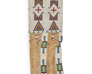 227
A Plains beaded hide tobacco bag
20th century; Northern/Central Plains
The bag with multi-colored beaded geometric motifs to each side and with tin cone accents
22.75" H x 7.75" W
Estimate: $800 - $1,200