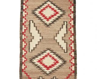 202
A Navajo double saddle blanket
Mid-20th century, Diné
Woven in grey, red, black, and cream wool with two serrated diamonds and floating stepped elements, with stepped borders to two sides
30.5" H x 61.5" W
Estimate: $300 - $500
