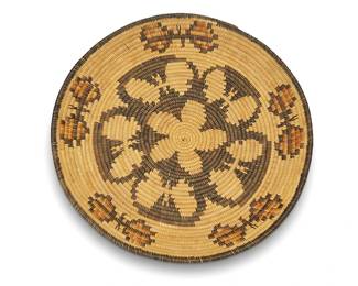 343
A polychrome Southwest pictorial basketry tray
Early/mid-20th century
A coiled flat basket with central floral and butterfly motifs, and a band of floating butterflies to rim
1.75" H x 14.25" Dia.
Estimate: $400 - $600