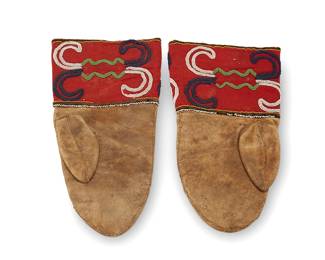 27
A pair of Cree beaded hide mittens
Late 19th century; Northern Great Plains/Canada
Each hide leather mitten with wide gauntlets featuring scrolled beadwork in white, dark blue, and green, worked on a red wool ground, with fine white bead edging
2 pieces
12" & 11.5" H x 6.625" W
Estimate: $300 - $500