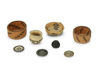 350
A group of miniature Native American baskets
Mid/late 20th century, Akimel O'odham & Tohono O'odham; Southwest United States
Comprising two small coiled Pima baskets, a coiled Papago basketry bowl, a coiled olla with rim ticking, as well as three diminutive coiled horsehair basketry trays and a tiny black coiled horsehair lidded olla
8 pieces
Largest: 1.5" H x 2.75" Dia.; Smallest: 1" H x 1" Dia.
Estimate: $200 - $400