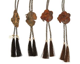 329
A group of Prix de West bolo ties
21st century
One signed to edge: Coleman
Four bolos by various artists including two 2012 bronze "Bison Medallion" bolos by Tim Cherry (each: 2.5" H x 2.5" W), a 2017 bronze Native American portrait bolo by John Coleman (3" H x 2.375" W), and a 2022 50th Anniversary bronze "Golden Wing" bolo by Gerald Balciar, with two commemorative charms (3.5" H x 1.75" W), each strung to a variegated brown and blonde braided horsehair cord with tassels
4 pieces
Cords: 44" L to 42" L
309.2 grams gross
Estimate: $200 - $400