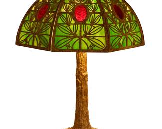 278
A Bradley & Hubbard slag glass table lamp
Early 20th century; Meriden, CT
Base marked to underside on applied pastille: B&H; base plate cover marked: B & H / 160; shade unmarked
The four-light lamp with cast verdigris bronze base, featuring a slag glass shade with "frog skin" patinated metal overlay depicting foliate motifs, surmounted by a pinecone finial, electrified
Lamp: 28.25" H x 10.75" Dia.; Shade: 10" H x 17.75" W x 20" D
Estimate: $1,200 - $1,800