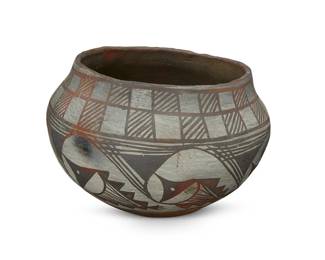 249
An Acoma Pueblo polychrome pottery jar
Early 20th century
Marked in slip paint to underside: Gallup. N.M. / June 1913
The three-color pot with banded checkered and fish motifs on a white slip glaze, above a terra cotta wash and puki indentation to underside
4.375" H x 6.625" Dia.
Estimate: $300 - $500