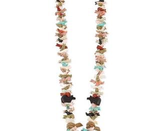 280
A Southwest Pueblo carved stone fetish necklace
Late 20th century
Featuring an elaborate single strand necklace of graduated stacked carved animal fetish figures, including bears, wolves, foxes, turtles and a large central carved jet standing bear, in various stones such as turquoise, mother of pearl, spiny oyster, jet, and pipestone, and with fine shell heishi and a traditional wrapped neck cord
32" L x 1.75" H
168.8 grams gross
Estimate: $200 - $400