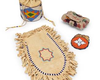233
A group of Native American beaded bags
Late 19th/early 20th century
Four works comprising a Haudenosaunee/Iroquois beaded "whimsey"-style rigid purple velvet envelope pouch/bag with top flap closure, worked in raised designs with clear and multicolored glass beads and with looped fringe to base (4.25" H x 6" W x 2.25" D), as well as three Plains-style beaded hide bags, each worked in polychrome geometric motifs including a small round bag/pouch (4.5" Dia.), a large soft hide bag with beaded star motifs and hide fringe edges (15" H x 10" W including fringe), and a drawstring "bucket" bag with an elaborate geometric rigid beaded strip and fine blue bead edging (9.5" H x 5.5" Dia.)
4 pieces
Estimate: $300 - $500