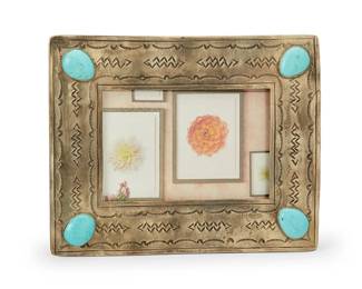 4
Late 20th/21st century
A Southwest-style silver and set stone picture frame
Stamped for shop verso: J. Alexander / [teepee motif]
Made from German silver, a "J. Alexander Rustic Silver" contemporary frame with stamped Southwest motifs to edges and four set blue stones to each corner, with glass insert
7.125" H x 9" W; opening verso: 4" x 6"
473.5 grams gross
Estimate: $200 - $400