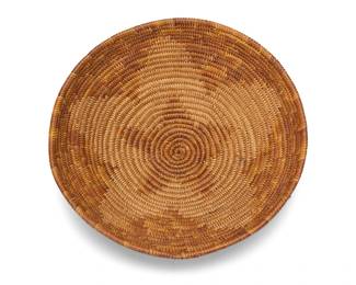 10
A polychrome California Mission basketry tray
Early 20th century; Southern California
A coiled low bowl with concentric five point stars/flower motifs in alternating positive and negative contrast
2.75" H x 9.25" Dia.
Estimate: $400 - $600