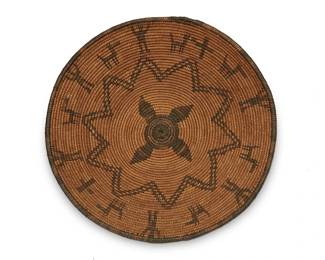 303
An Apache pictorial basketry tray
Early 20th century; Southwest United States
A large coiled flared basket with central starburst and small pinwheel motif, surrounded by alternating dogs and standing figures with uplifted arms
3.5" H x 13.75" Dia.
Estimate: $600 - $900
