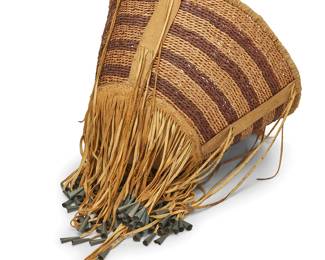 315
An Apache burden basket
Early/mid-20th century; Southwest United States
A tall tapered twined basket featuring hide strapping to rim and sides and hide reinforcement to underside, adorned with hide fringe accents terminating in metal cones
13.5" H x 19.5" Dia.; Fringe: 12" L approximately
Estimate: $300 - $500