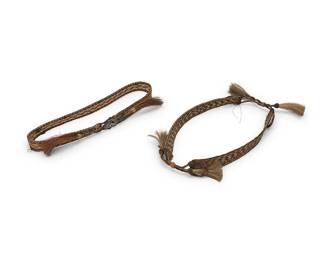 328
Two Western horsehair hat bands
Mid-20th century
Each adjustable band of braided horsehair, in dark brown, tan, and blonde herringbone-style designs, each terminating in small tassels, and one with a stamped silver star ornament and small rivets
2 pieces
Larger: 1" H x 23" Dia.; Smaller: 0.875" H x 22.75" Dia.
Estimate: $100 - $200