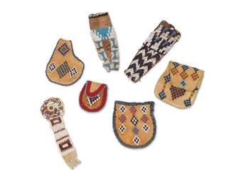 235
A group of Plains beaded hide bags and pouches
Late 19th/early 20th century
Seven works comprising a beaded soft hide watch fob with fringed end (7" H x 2.125" W), two small beaded deer tail hide bags, each with blue and white beading in geometric stepped and zigzag motifs (8.5" H x 2.75" W & 8" H x 2.5" W), and four small soft hide beaded bags/pouches, each with multicolored stepped diamond motifs and beaded edging, two with flaps and fabric trim (largest: 5.5" H x 4" W; smallest: 3.25" H x 2.75" W)
7 pieces
Estimate: $300 - $500