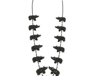 282
A Southwest Zuni-style carved jet bear fetish necklace
Late 20th century
Comprising a single strand necklace with carved jet bears and a central standing bear, with jet and turquoise heishi and a silver cone clasp
32.5" L x 1.75" H
74.0 grams gross
Estimate: $200 - $400