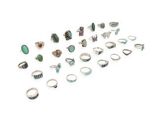 380
A group of Southwest silver and stone set rings
Mid/late 20th century
Twelve variously marked for maker: L.L.Lee [for Larson L Lee, Navajo/Diné] / Paloma / RG+/ZI / P.D.Coonsis [Zuni] / LL / TK [stylized with double feather, for Ray Tracey (Navajo/Diné)/Knifewing Segura] / TK / L. Bennett [for Lee Bennett, Navajo/Diné]; eleven marked for sterling
A large group featuring various stones including turquoise, coral, lapis lazuli, amber, sugilite, mother of pearl, and malachite, in various styles including bezel-set, cluster-set, mosaic inlay, and silver overlay, and figural motifs including a turtle and a butterfly
32 pieces
Ring sizes: 11.5 to 4.5
121.0 grams gross
Estimate: $200 - $400