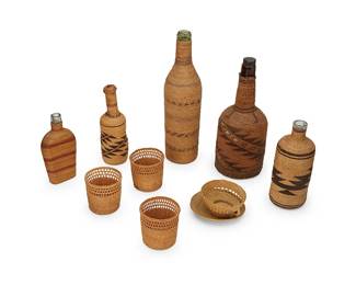 368
A group of Makah/Tlingit bottle baskets and basketry items
Early/mid-20th century; Pacific Northwest Coast
Comprising five twined basketry covered glass bottles of various sizes and designs, including two with polychrome banding, three with sawtooth zigzag and diagonal motifs, including one polychrome with yellow quill imbricated diamonds, as well as three basketry glass covers with lattice rims and twill banding, and a stiffened knotwork cup and saucer
10 pieces
Largest bottle: 12" H x 3.25" Dia.; Smallest: 6.125" H x 3.125" W x 1.25" D; Covers: 2.75" H x 3" Dia.; Cup: 1.75" H x 3.5" Dia.; Saucer: 0.75" H x 4.25" Dia.
Estimate: $400 - $600