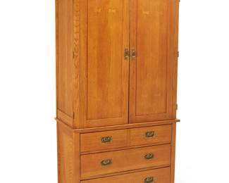 63
A Contemporary Mission-style wardrobe
Early 21st century
Lower console with burn mark to upper drawer interior: Bassett / Made in USA; each numbered with factory stencil verso
The wood wardrobe with brass hardware, comprising an upper console with two hinged cabinet doors revealing two adjustable shelves, a sliding shelf, and a single drawer, above a lower console with five drawers
2 pieces
Upper console: 47.5" H x 38.25" W x 20.25" D; Lower console: 30.5" H x 38.25" W x 20.25" D
Estimate: $800 - $1,200