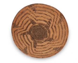 333
A Pima basketry tray
Early 20th century, Akimel O'odham; Southwest United States
A large coiled shallow bowl with stepped radiating pinwheel star motif
5" H x 14.5" Dia.
Estimate: $400 - $600