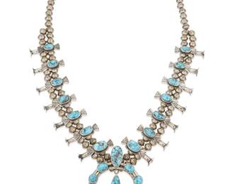 324
A Navajo sterling silver and turquoise squash blossom necklace
Mid/late 20th century, Diné
Appears unmarked
A sterling silver and set turquoise necklace with fourteen stamped butterfly "blossoms" and a central naja with teardrop dangle
26.25" L x 2.75" H
135.1 grams gross
Estimate: $700 - $900