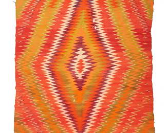 196
A large Navajo Germantown eyedazzler rug
Late 19th century, Diné
Woven in red, orange, purple, cream, and green multicolored wools with a central radiating diamond
82" H x 58.5" W
Estimate: $800 - $1,200