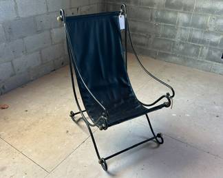 Statement regency leather sling chair. Iron base.