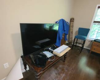Coffee table, TV works, rug, and stool.