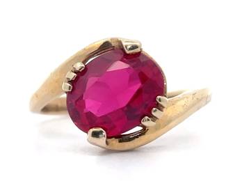 Oval Ruby Solitaire Bypass Ring in Yellow Gold