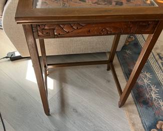 Glass topped carved side table