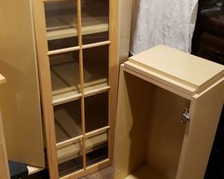 Corner wall cabinet with glass and natural maple door.