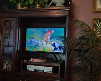 Basement left, nice dark wood (cherry?) media cabinet. Two DVD/VHS combos for sale.