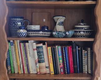 This shelf is in the kitchen and displays polish patterned pottery.