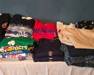 Lots of KU tshirts, upstairs bedroom to the right.