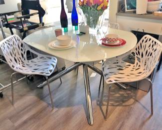Italian White Glass / Chrome Dining Table by Modani. It revolves and two leaves rise up to make the table seat 6.