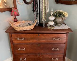 Early American handmade chest of drawers with glass knobs, costume jewelry, vintage lap, vintage frames