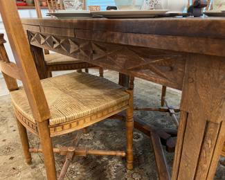 Showing the side stretcher of the oak table and details of the chairs