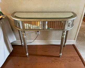 Glass and mirror accent table with storage cupboard