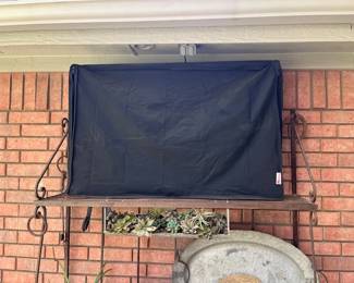 On the patio you will find this Vizio 42" TV with cover and hanger