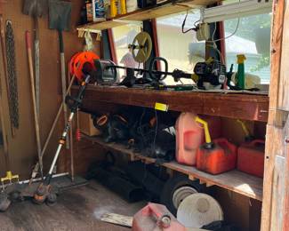 Lots of yard tools and gardening supplies.