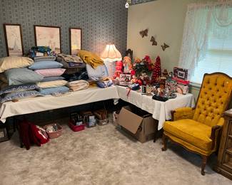 Lots of pillows, blankets and towels. Vintage wall art.