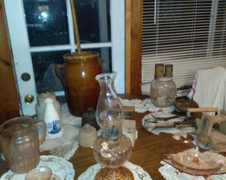 Pink depression glass water pitcher and org kerosene lamp