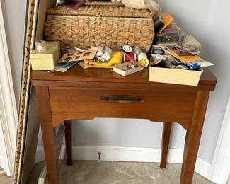 Sewing machine in wood cabinet and many notions