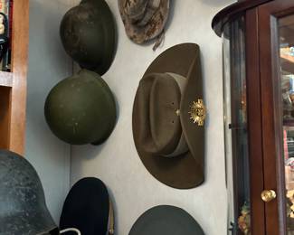 5th Battalion, Company C British helmet, German WWII Luftschutz civil defense helmet, US Army officer's dress visor cap, Australian Army Slouch hat, US M1 steel helmet, Belgian post WWII army helmet, Civil War Reproduction hats, and more.