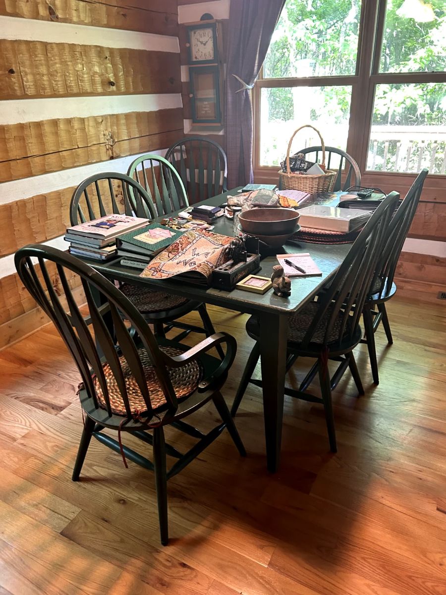 includes 8 chairs and 1 leaf for expansion.  Zoom in on the color. sturdy. If purchased at full price it will  included the woven seat pads, placemats & trivets.