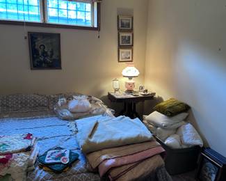 Linens. Pillows. Antique lamp. Pictures.