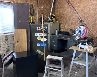 Metal desk. Stools. Saw. Filing cabinet.