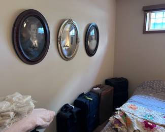 Antique family portraits. Luggage. Quilts.
